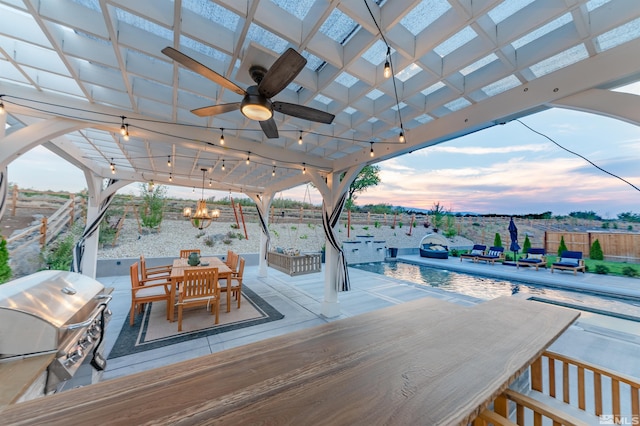 1009 Tremolite, Reno, NV 89511 - deck at dusk featuring grilling area, outdoor dining area, fence, a patio, and a ceiling fan