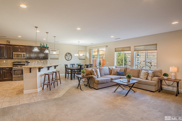 6680 Voyage Dr, Sparks, NV 89436 - living area with recessed lighting, light tile patterned floors, light colored carpet, baseboards, and a chandelier