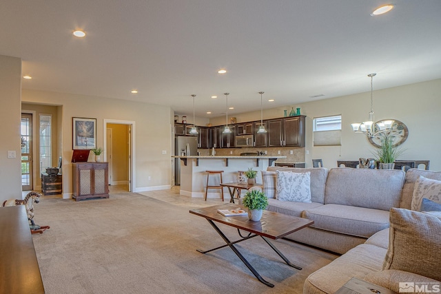 6680 Voyage Dr, Sparks, NV 89436 - living room featuring recessed lighting, a chandelier, baseboards, and light colored carpet