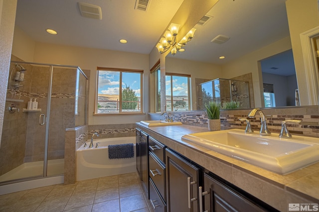 6680 Voyage Dr, Sparks, NV 89436 - full bath featuring tile patterned floors, a shower stall, a chandelier, a garden tub, and decorative backsplash