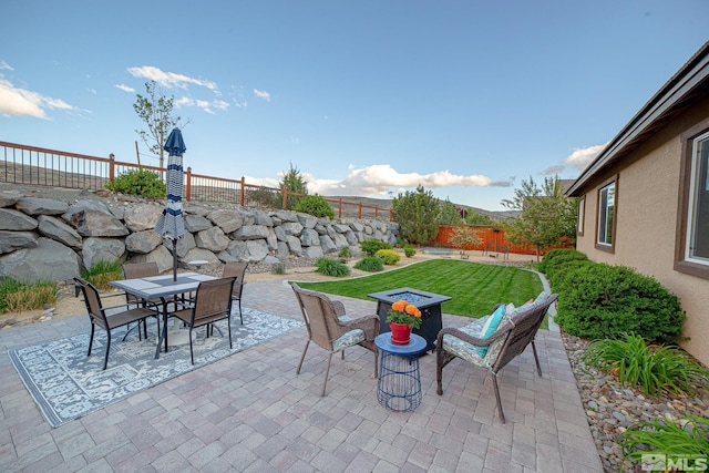 6680 Voyage Dr, Sparks, NV 89436 - fenced backyard featuring a patio area, outdoor dining space, and an outdoor fire pit