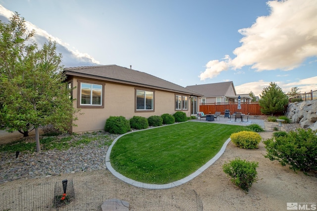 6680 Voyage Dr, Sparks, NV 89436 - rear view of property with a patio, stucco siding, and a tile roof