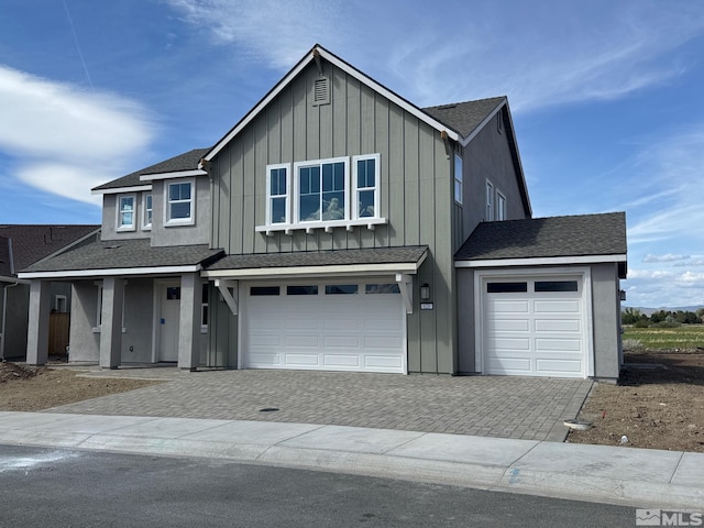 620 Sage Grouse Loop, Gardnerville, NV 89460 - view of front facade with board and batten siding, decorative driveway, a garage, and a shingled roof