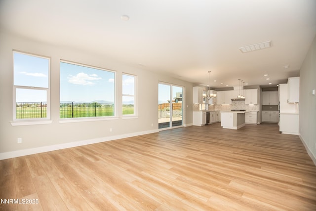 620 Sage Grouse Lp, Gardnerville, NV 89460 - unfurnished living room featuring a chandelier, light wood-style floors, baseboards, and recessed lighting