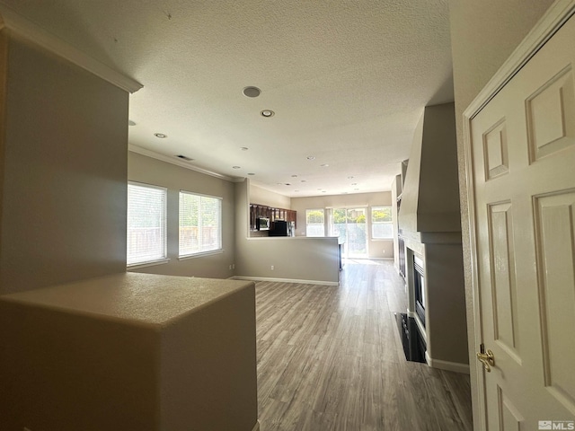 10599 Crystal Bay Dr, Reno, NV 89521 - corridor with wood finished floors, baseboards, crown molding, a textured ceiling, and recessed lighting