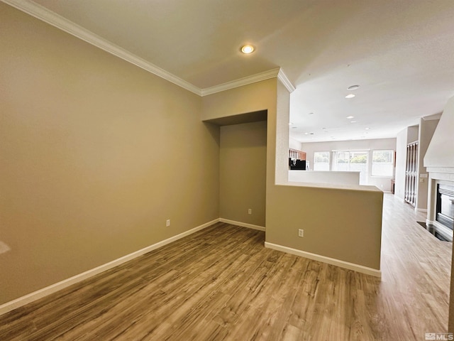 10599 Crystal Bay Dr, Reno, NV 89521 - unfurnished living room featuring baseboards, wood finished floors, crown molding, recessed lighting, and a glass covered fireplace