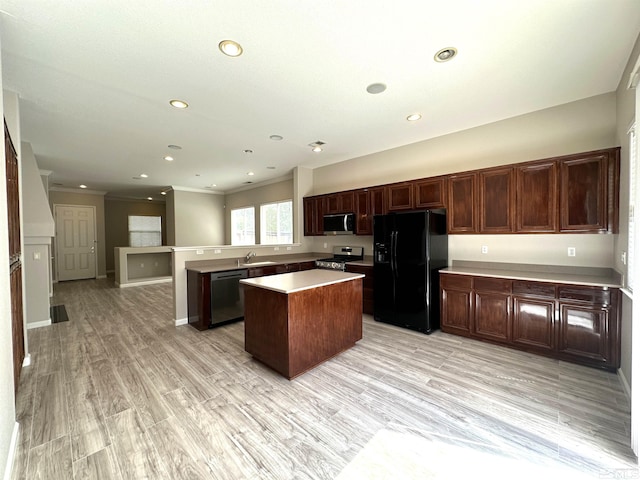 10599 Crystal Bay Dr, Reno, NV 89521 - kitchen featuring appliances with stainless steel finishes, a sink, a center island, crown molding, and light countertops