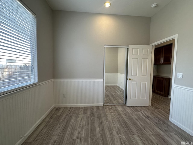 10599 Crystal Bay Dr, Reno, NV 89521 - unfurnished bedroom featuring a wainscoted wall, dark wood-style flooring, and a closet