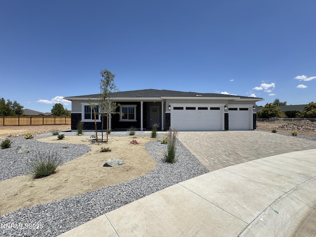 638 Sage Grouse Lp, Gardnerville, NV 89460 - ranch-style home with decorative driveway, a garage, and covered porch