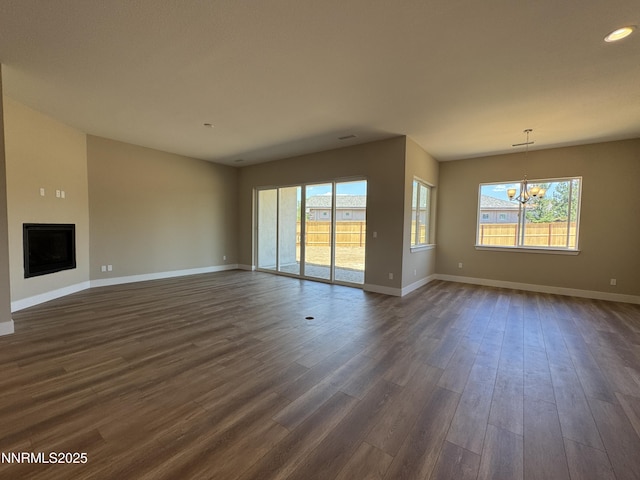 638 Sage Grouse Lp, Gardnerville, NV 89460 - unfurnished living room with a chandelier, dark wood-type flooring, a fireplace, and recessed lighting