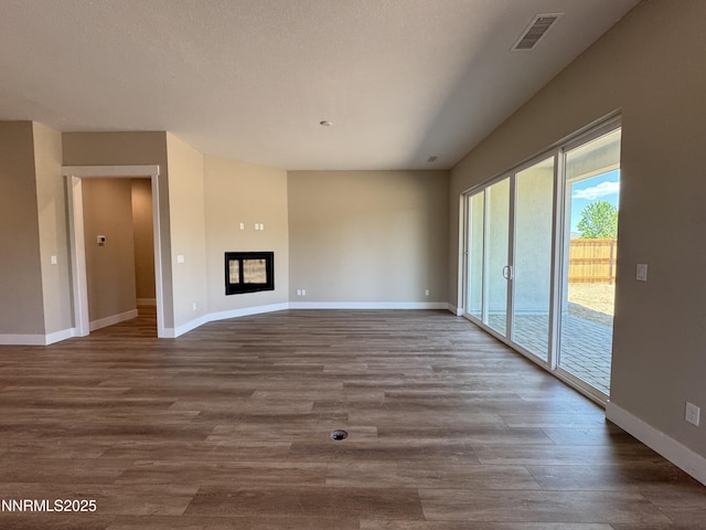638 Sage Grouse Lp, Gardnerville, NV 89460 - unfurnished living room featuring wood finished floors and a glass covered fireplace