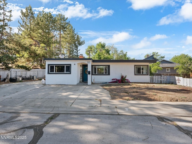 665 Southworth Dr, Reno, NV 89512 - ranch-style home featuring stucco siding, driveway, and a chimney