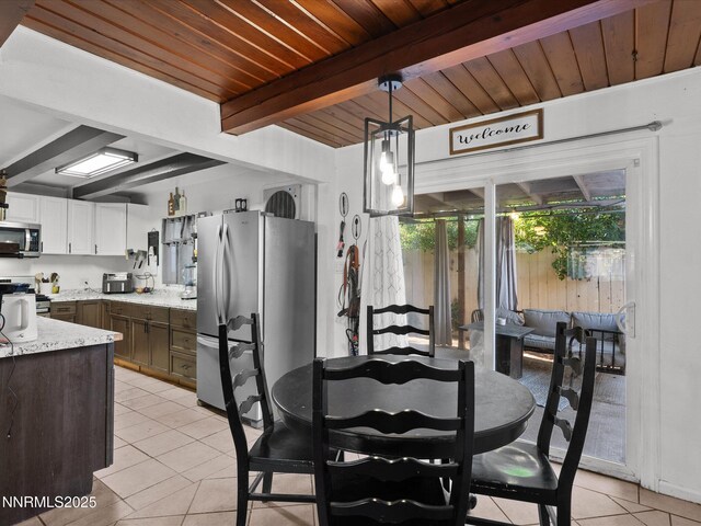 665 Southworth Dr, Reno, NV 89512 - dining space featuring light tile patterned floors and wood ceiling with exposed beams