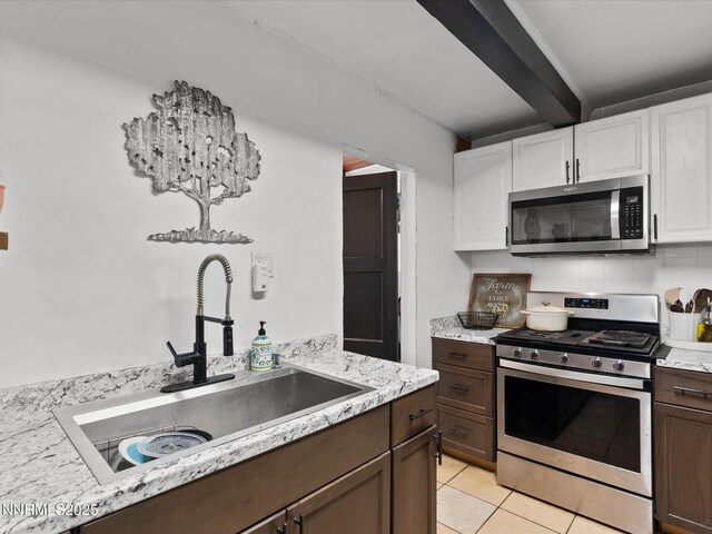 665 Southworth Dr, Reno, NV 89512 - kitchen with appliances with stainless steel finishes, a sink, beam ceiling, white cabinets, and light tile patterned floors