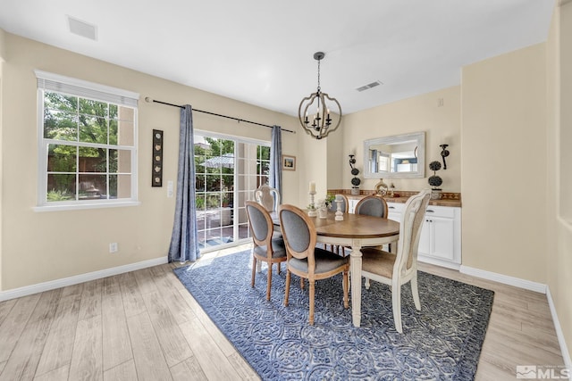 2374 Roman Dr, Sparks, NV 89434 - dining area with a chandelier, light wood-style flooring, and baseboards