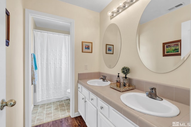 2374 Roman Dr, Sparks, NV 89434 - bathroom featuring toilet, double vanity, a shower with curtain, and wood finished floors