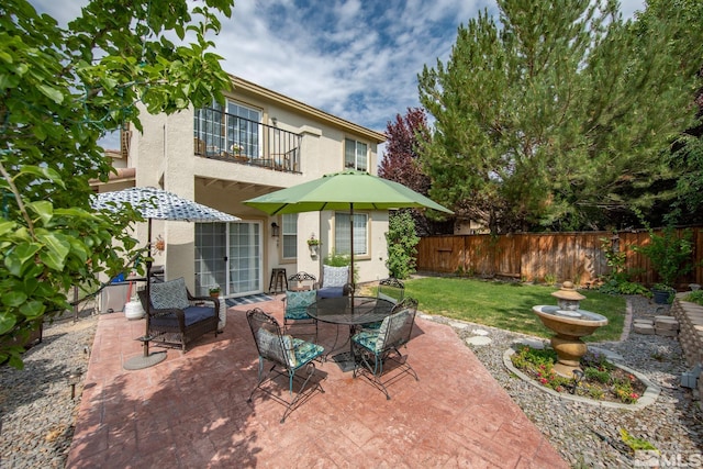 2374 Roman Dr, Sparks, NV 89434 - back of property with a balcony, a patio, stucco siding, and outdoor dining space