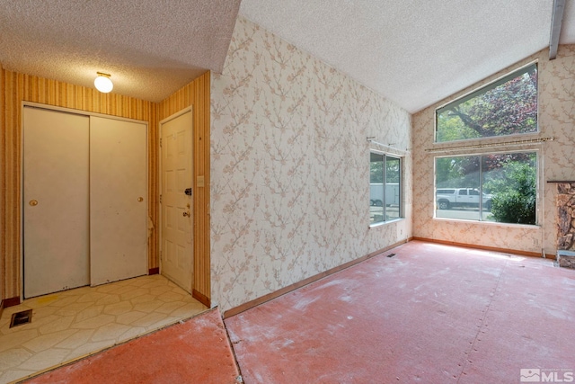 966 Woodstone Dr, Sparks, NV 89434 - foyer with a textured ceiling, wallpapered walls, lofted ceiling, and baseboards
