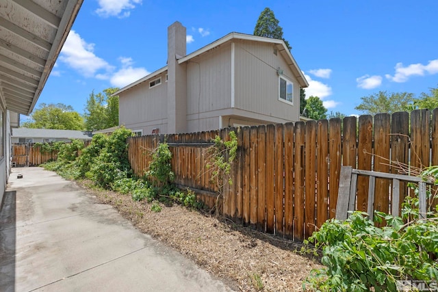 966 Woodstone Dr, Sparks, NV 89434 - view of home's exterior with fence and a chimney