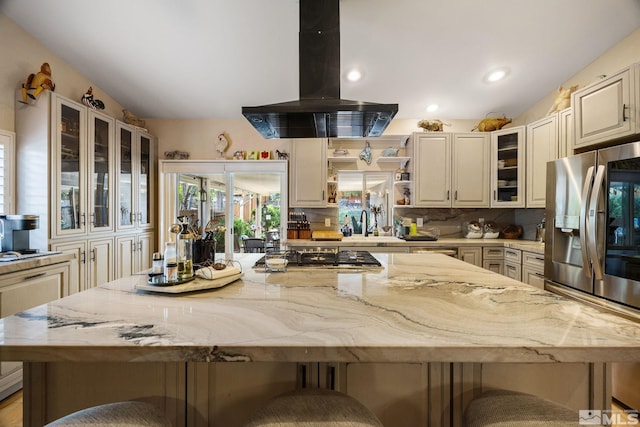 6525 Monticello Ct, Reno, NV 89519 - kitchen with island range hood, stainless steel appliances, a center island, a kitchen bar, and decorative backsplash