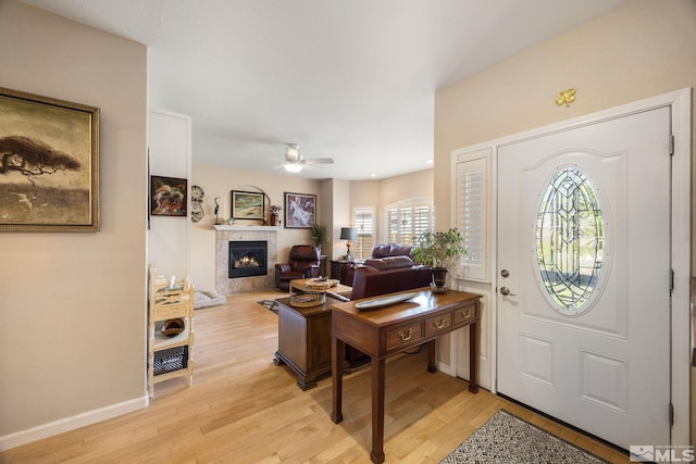6525 Monticello Ct, Reno, NV 89519 - foyer featuring a ceiling fan, plenty of natural light, light wood-style floors, and a glass covered fireplace