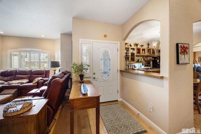 6525 Monticello Ct, Reno, NV 89519 - foyer with wood finished floors, arched walkways, and baseboards