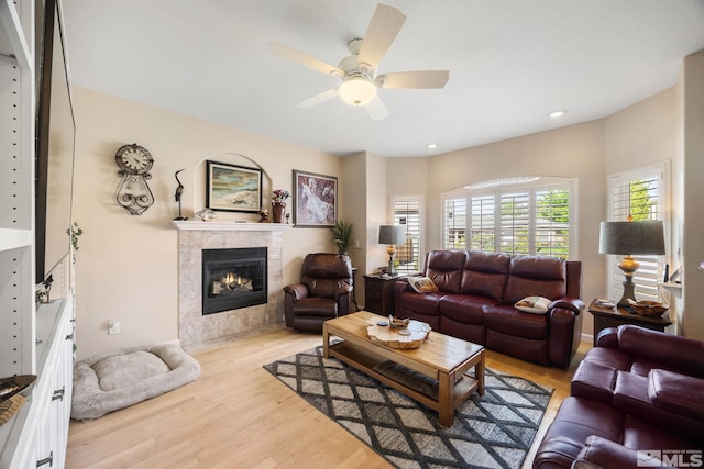 6525 Monticello Ct, Reno, NV 89519 - living area with a tile fireplace, light wood-style floors, a ceiling fan, and recessed lighting