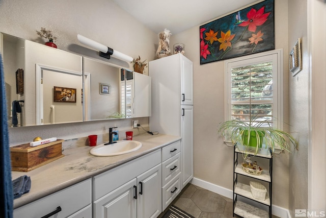 6525 Monticello Ct, Reno, NV 89519 - bathroom with tile patterned floors, vanity, and baseboards