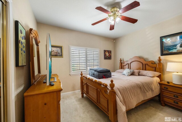 6525 Monticello Ct, Reno, NV 89519 - bedroom featuring light colored carpet, a ceiling fan, and baseboards