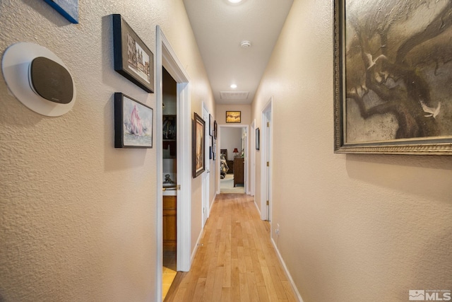 6525 Monticello Ct, Reno, NV 89519 - corridor featuring light wood finished floors, recessed lighting, baseboards, and a textured wall