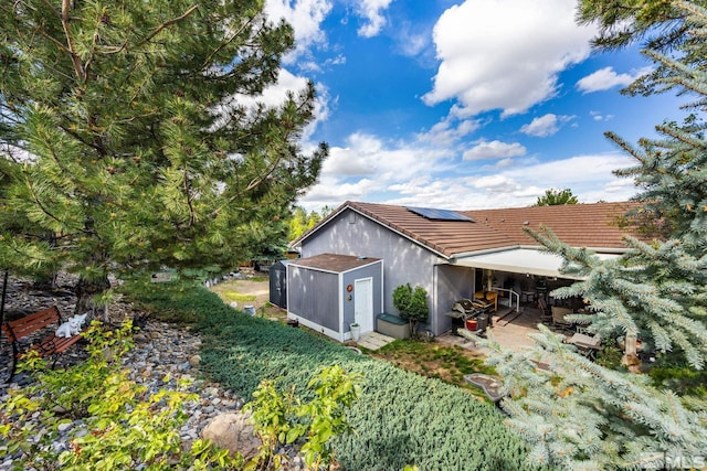 6525 Monticello Ct, Reno, NV 89519 - back of property featuring a patio, solar panels, a tiled roof, and stucco siding