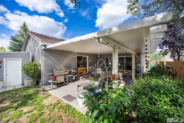 6525 Monticello Ct, Reno, NV 89519 - back of property featuring fence, a patio, stucco siding, and an outdoor hangout area