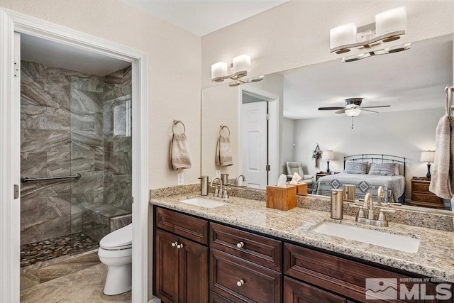 1051 Tenabo Ln, Gardnerville, NV 89410 - ensuite bathroom featuring a shower stall, toilet, ceiling fan, and double vanity