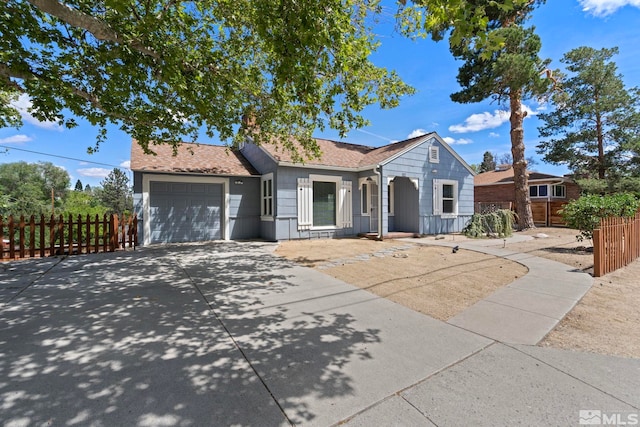 2066 Plumas St, Reno, NV 89509 - ranch-style house with an attached garage, concrete driveway, fence, and a shingled roof