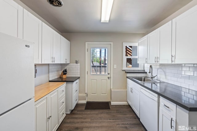 2066 Plumas St, Reno, NV 89509 - kitchen featuring white appliances, a sink, dark wood-style flooring, backsplash, and white cabinetry
