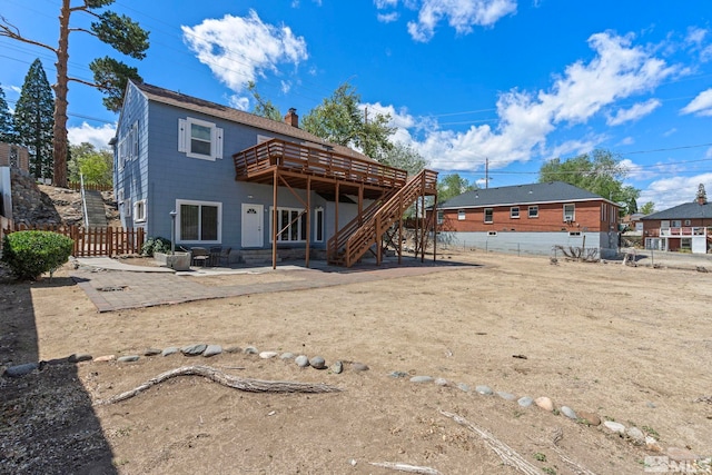 2066 Plumas St, Reno, NV 89509 - back of house with a wooden deck, a patio area, a fenced backyard, a chimney, and stairs