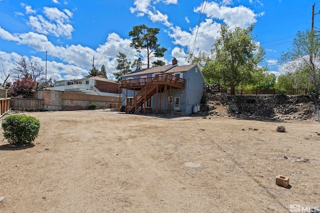 2066 Plumas St, Reno, NV 89509 - back of house with a wooden deck, stairway, and a fenced backyard