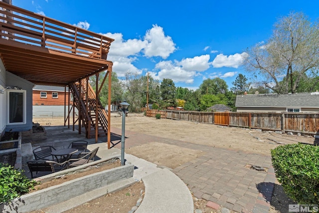 2066 Plumas St, Reno, NV 89509 - fenced backyard featuring stairs, a patio, and a deck