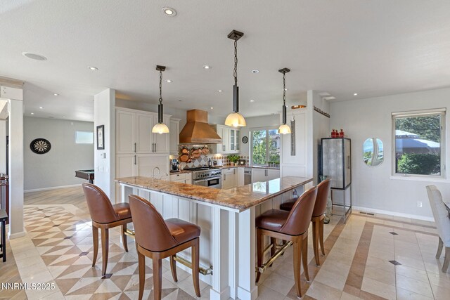 10286 Morning Song Trl, Reno, NV 89511 - kitchen with custom exhaust hood, high end stainless steel range, baseboards, white cabinets, and recessed lighting