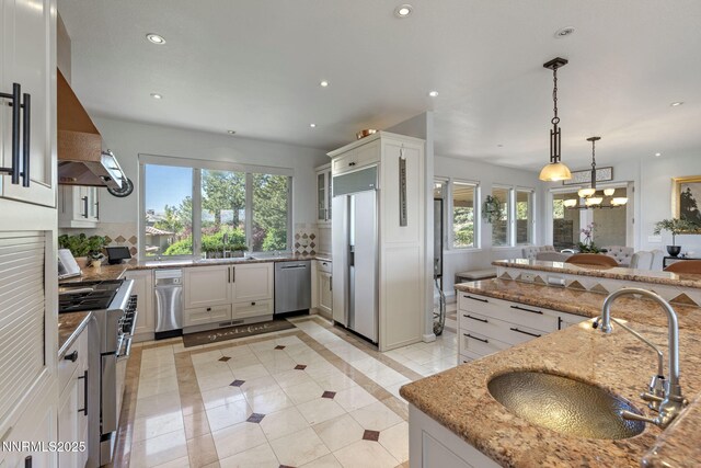 10286 Morning Song Trl, Reno, NV 89511 - kitchen with high quality appliances, a sink, plenty of natural light, recessed lighting, and wall chimney exhaust hood