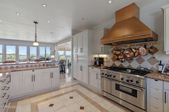 10286 Morning Song Trl, Reno, NV 89511 - kitchen with range with two ovens, custom range hood, recessed lighting, stone counters, and decorative backsplash