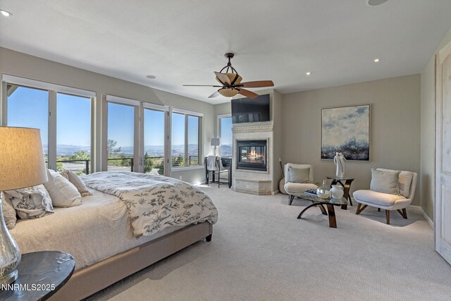 10286 Morning Song Trl, Reno, NV 89511 - bedroom featuring a glass covered fireplace, carpet floors, recessed lighting, ceiling fan, and baseboards
