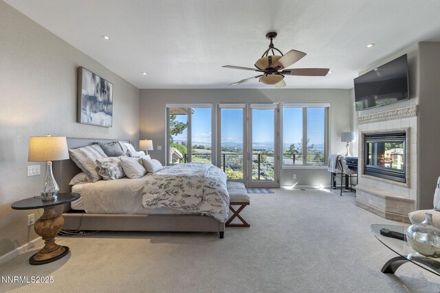 10286 Morning Song Trl, Reno, NV 89511 - carpeted bedroom with multiple windows, access to outside, a fireplace, baseboards, and recessed lighting
