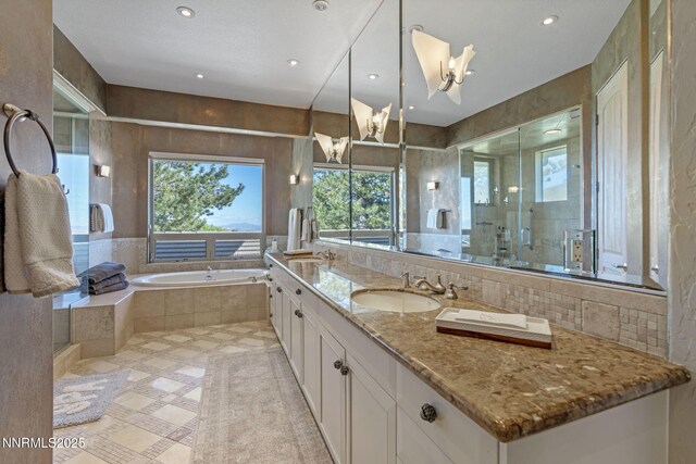 10286 Morning Song Trl, Reno, NV 89511 - bathroom with a bath, a stall shower, vanity, a chandelier, and recessed lighting