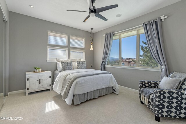 10286 Morning Song Trl, Reno, NV 89511 - bedroom with light carpet, multiple windows, baseboards, and ceiling fan