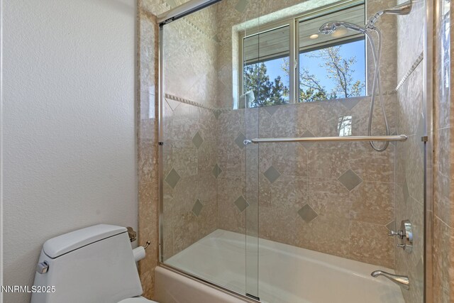10286 Morning Song Trl, Reno, NV 89511 - bathroom with combined bath / shower with glass door, toilet, and a textured wall