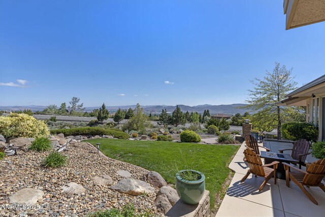 10286 Morning Song Trl, Reno, NV 89511 - view of grassy yard featuring a patio and a mountain view