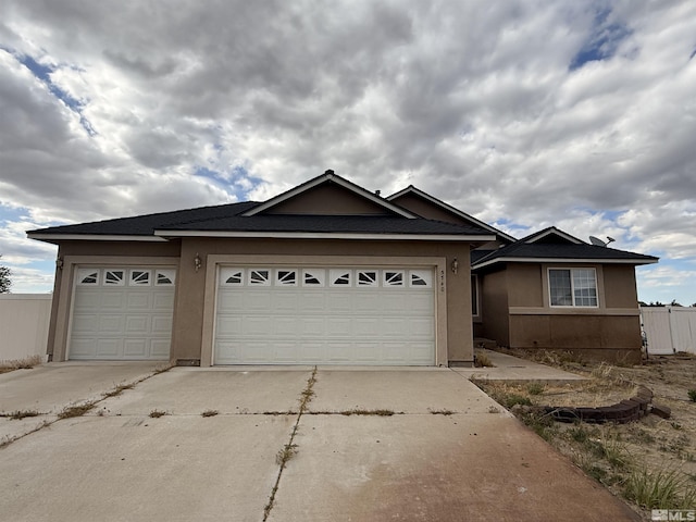 5740 Sarah Rd, Fallon, NV 89406 - ranch-style house with driveway, stucco siding, and a garage