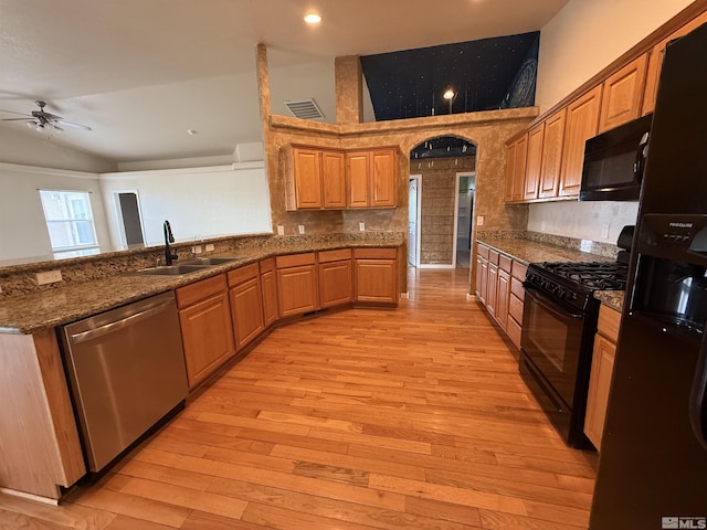 5740 Sarah Rd, Fallon, NV 89406 - kitchen featuring black appliances, a sink, a ceiling fan, light wood finished floors, and dark stone counters