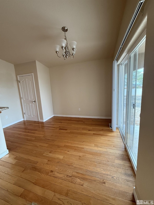 5740 Sarah Rd, Fallon, NV 89406 - unfurnished room featuring light wood-style flooring, a chandelier, and baseboards